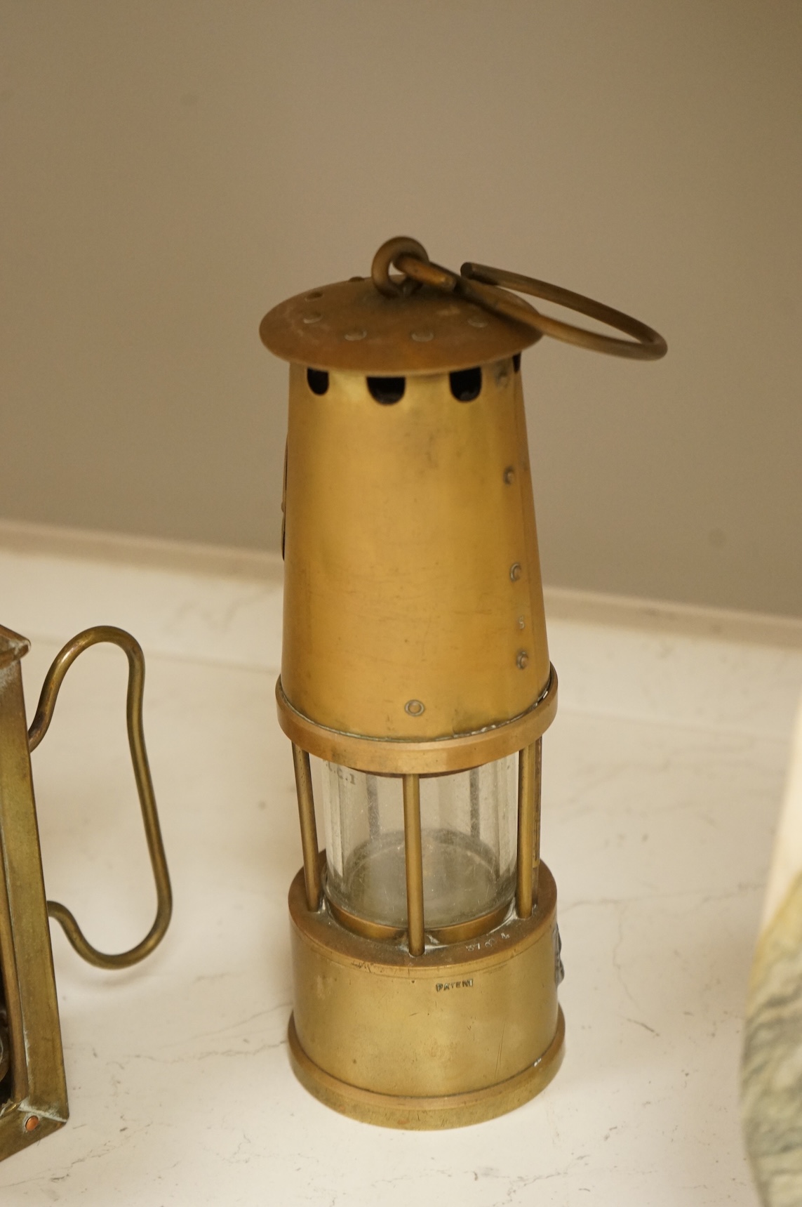 A railway lamp, a vintage Eccles Protector miners lamp and another, largest 17cm high